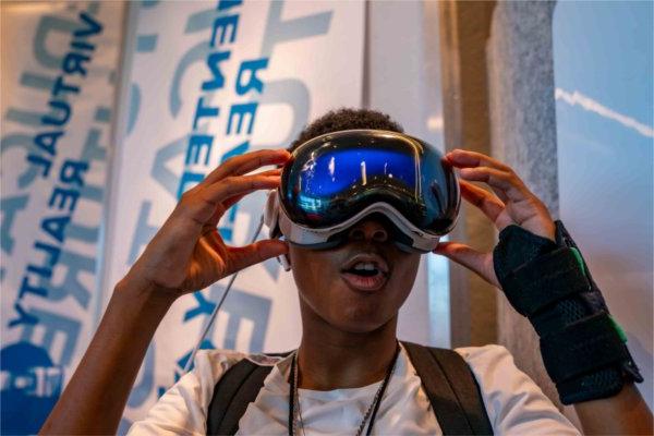  A student reacts to looking through virtual reality goggles. 