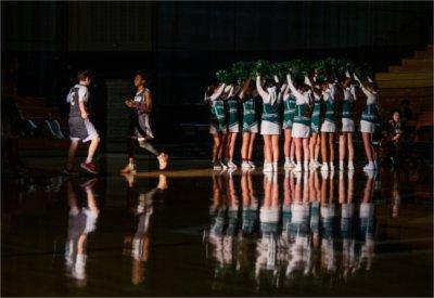 Basketball player is introduced to the crowd before the start of a charter middle school game at the Fieldhouse.